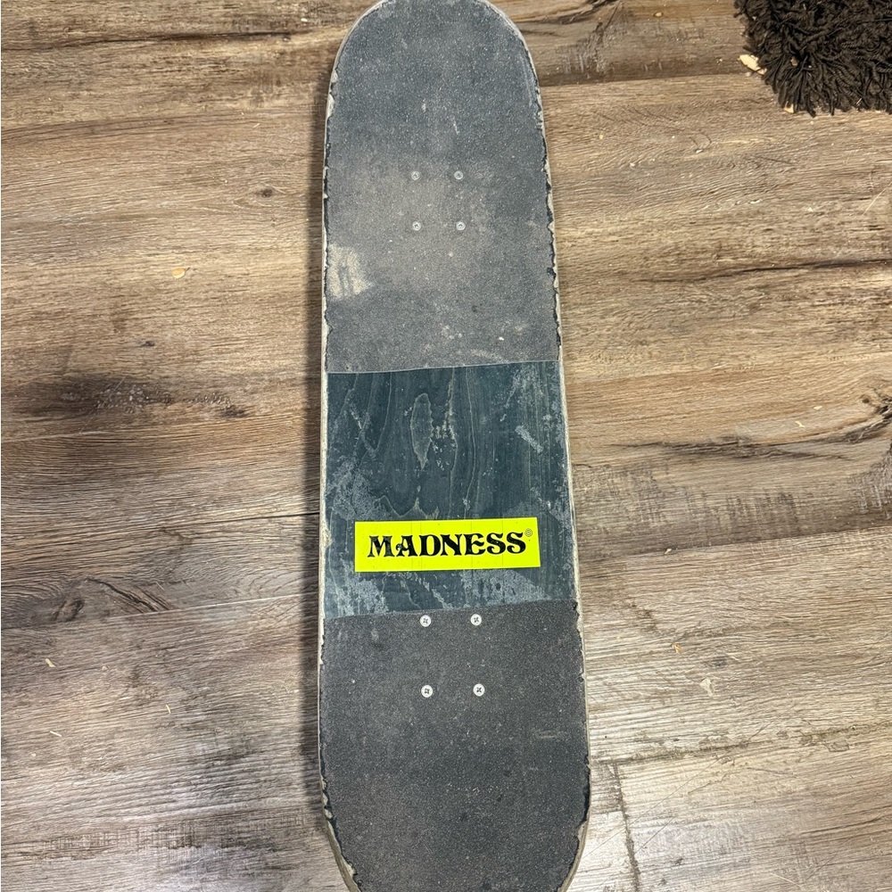Madness Skateboard Deck with Black Grip Tape